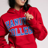 Person wearing a red 'Hanover College' hoodie against a plain background