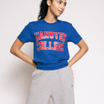 Person wearing a blue 'Hanover College' t-shirt and gray sweatpants on a white background