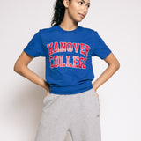 Person wearing a blue 'Hanover College' t-shirt and gray sweatpants on a white background