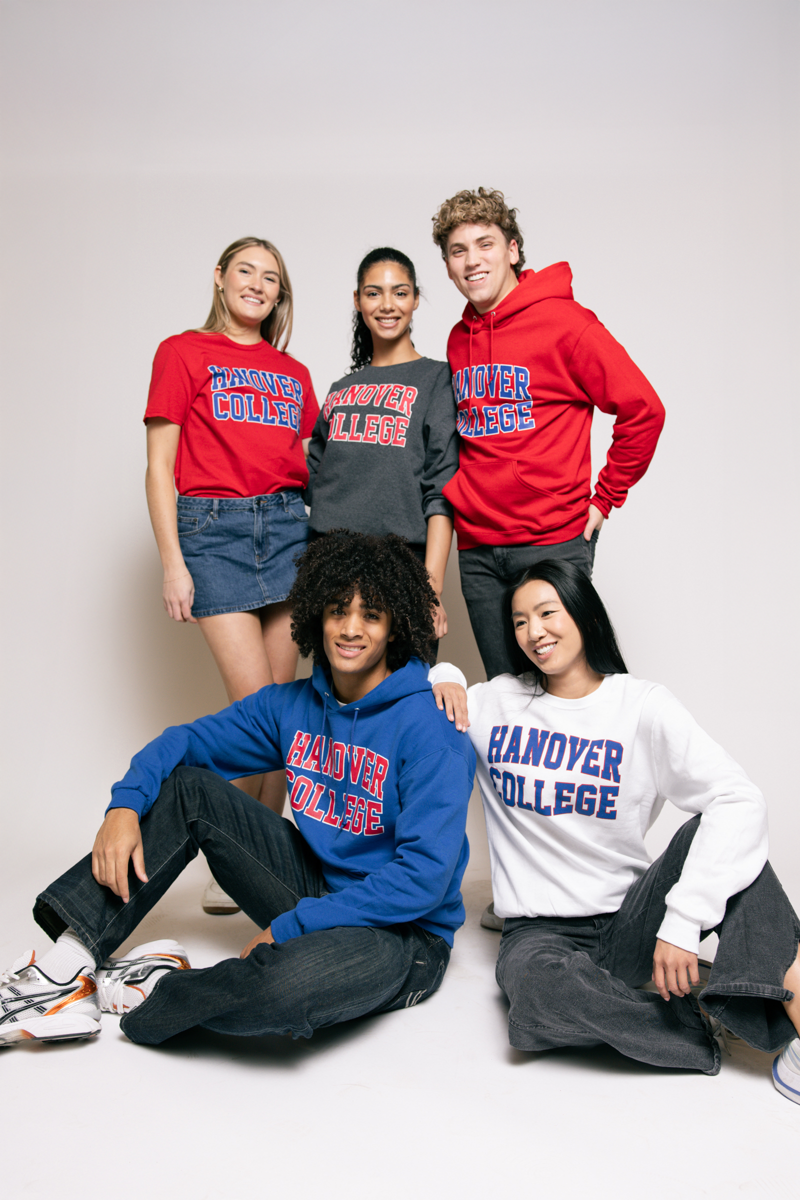 Five students wearing Hanover College sweatshirts on a white background