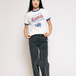 Person wearing a vintage-style 'Hawkeye Panthers' t-shirt and dark jeans on a plain background