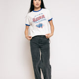 Person wearing a vintage-style 'Hawkeye Panthers' t-shirt and dark jeans on a plain background