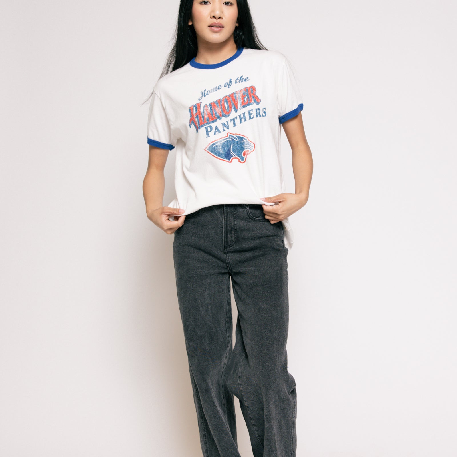 Person wearing a vintage-style 'Hawkeye Panthers' t-shirt and dark jeans on a plain background