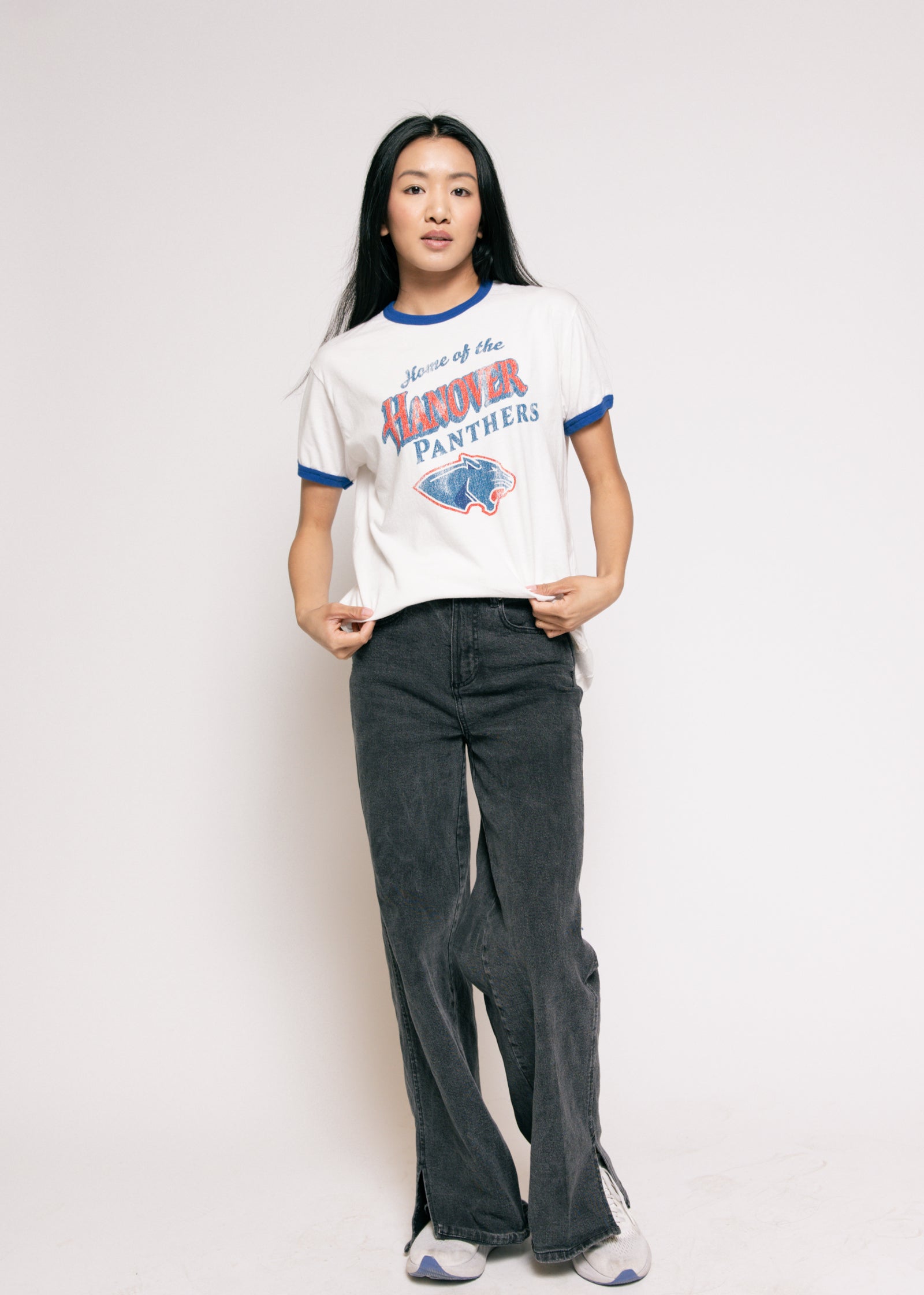 Person wearing a vintage-style 'Hawkeye Panthers' t-shirt and dark jeans on a plain background