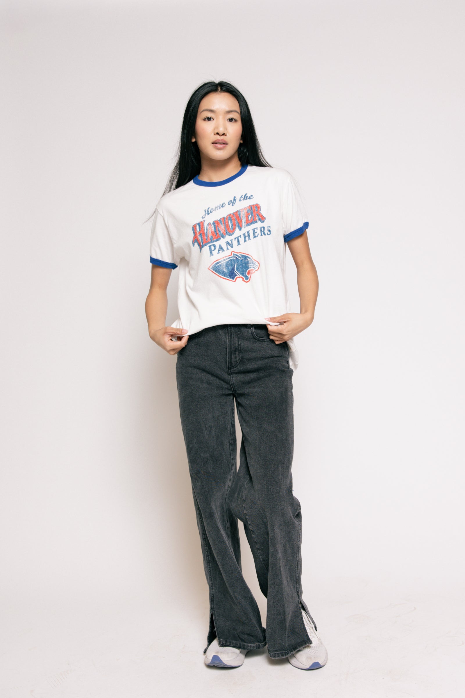 Person wearing a vintage-style 'Hawkeye Panthers' t-shirt and dark jeans on a plain background